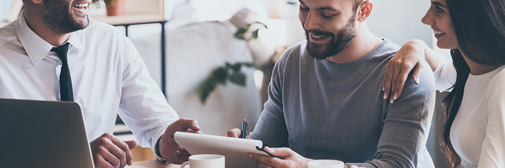Picture of a smiling man completing paperwork