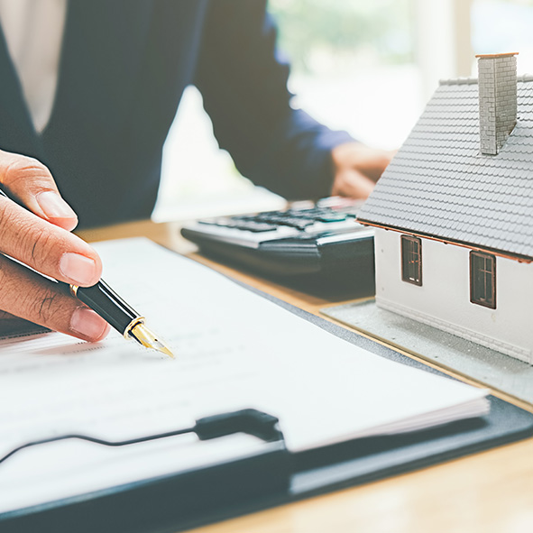 Person writing on property document