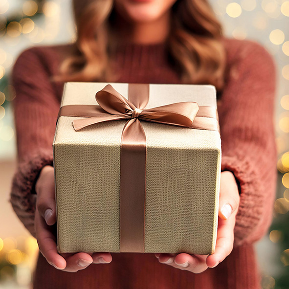 Person holding out a nicely wrapped gift