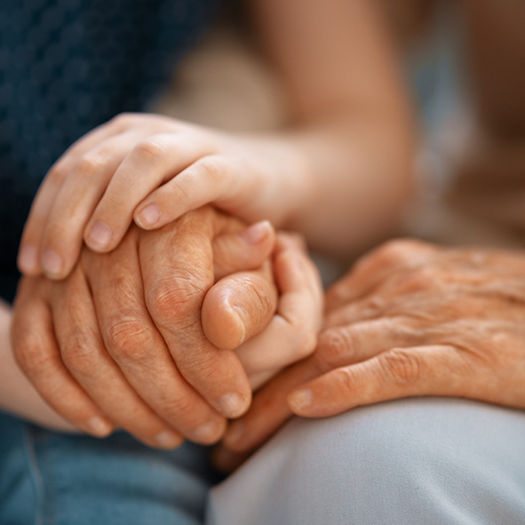 Young woman comforting elderly woman