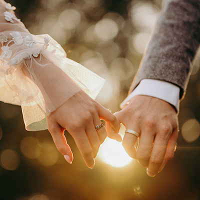 Should You Get Married to Save Inheritance Tax? - Picture of a couple linking fingers on their wedding day